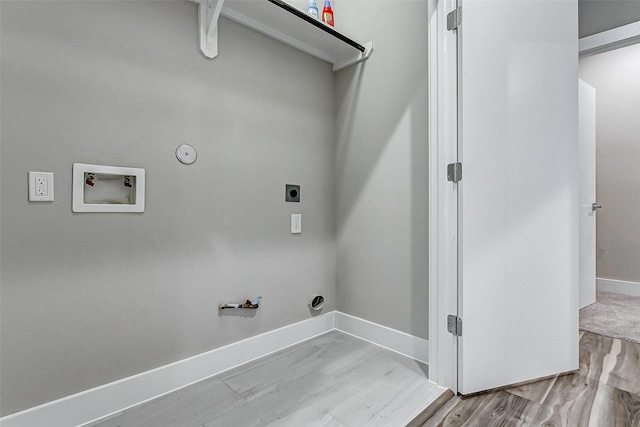 laundry area featuring washer hookup, hookup for a gas dryer, light hardwood / wood-style flooring, and electric dryer hookup