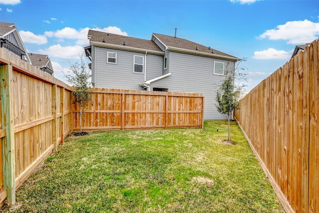 rear view of property with a yard