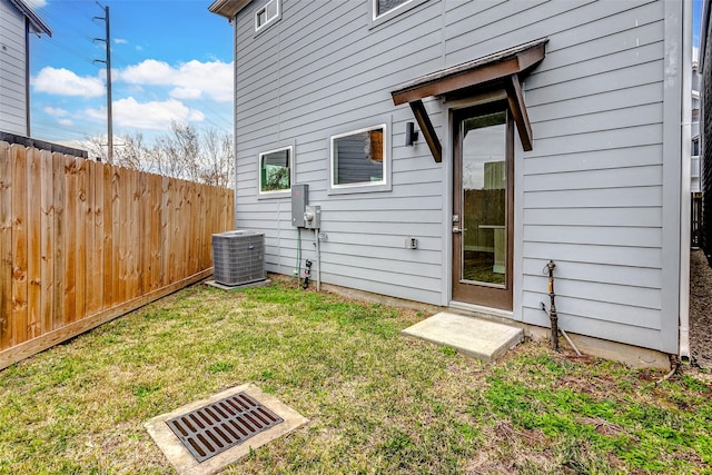 exterior space featuring central AC and a lawn