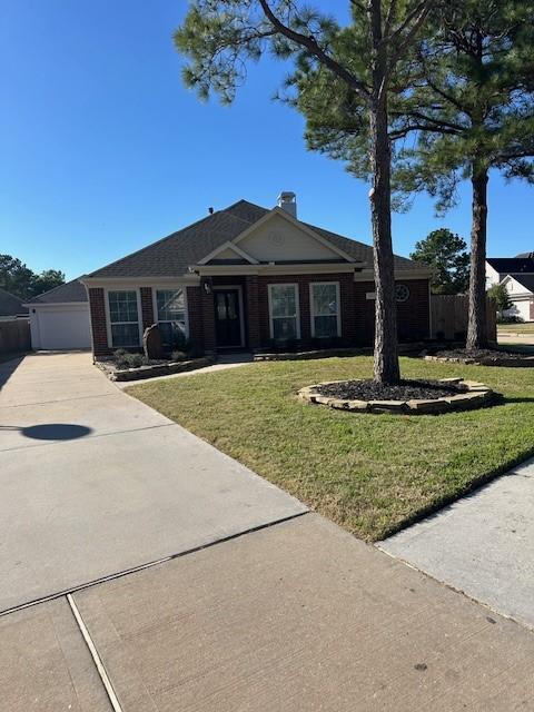 ranch-style house with a front yard and a garage