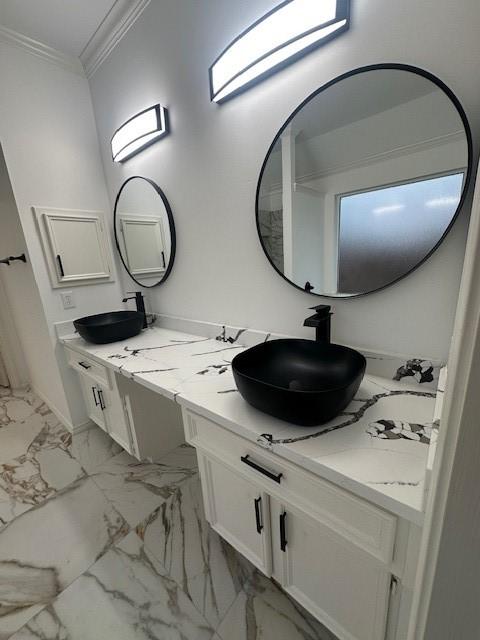 bathroom with crown molding and vanity