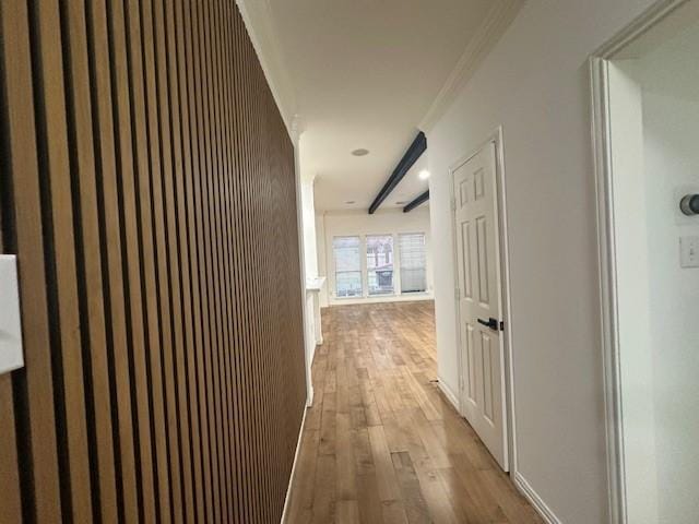 corridor with crown molding and light wood-type flooring