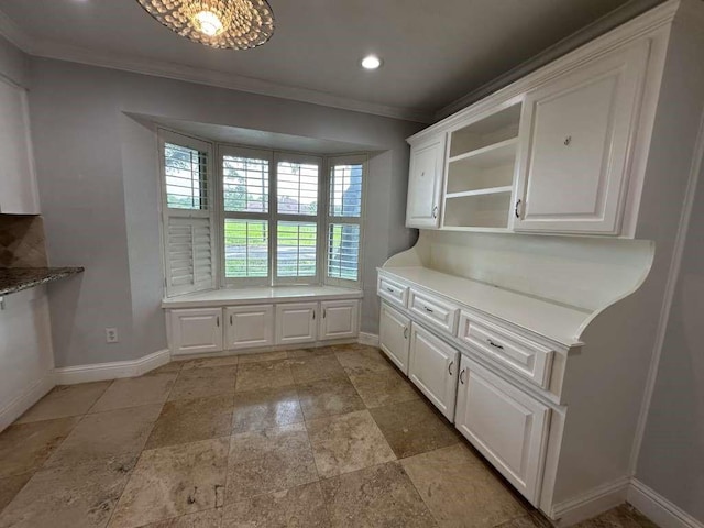 kitchen with white cabinets and ornamental molding