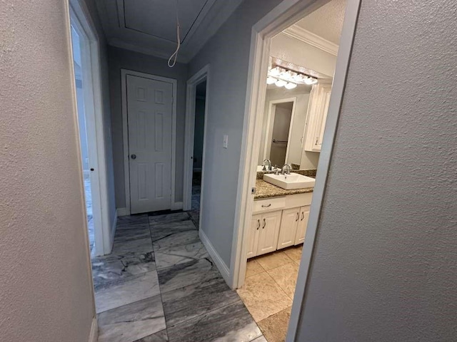 hallway featuring sink and ornamental molding