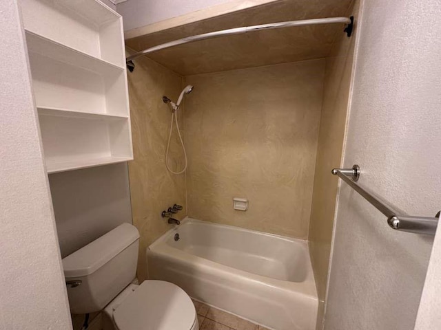 bathroom with toilet, tile patterned flooring, and washtub / shower combination