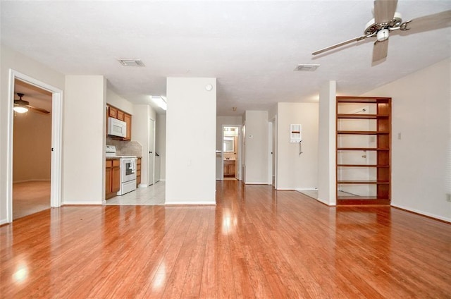 unfurnished living room with ceiling fan and light hardwood / wood-style floors