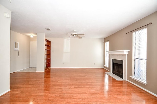 unfurnished living room with ceiling fan and light hardwood / wood-style floors