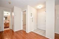 hallway with hardwood / wood-style floors