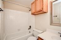 full bathroom with shower / bathing tub combination, toilet, and vanity