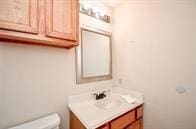 bathroom featuring toilet and vanity