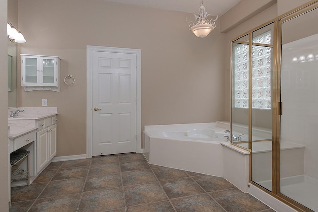 bathroom with vanity and shower with separate bathtub