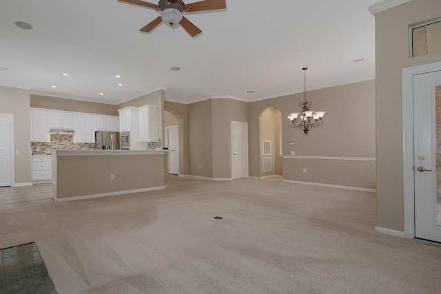 unfurnished living room with ceiling fan, ornamental molding, and light carpet