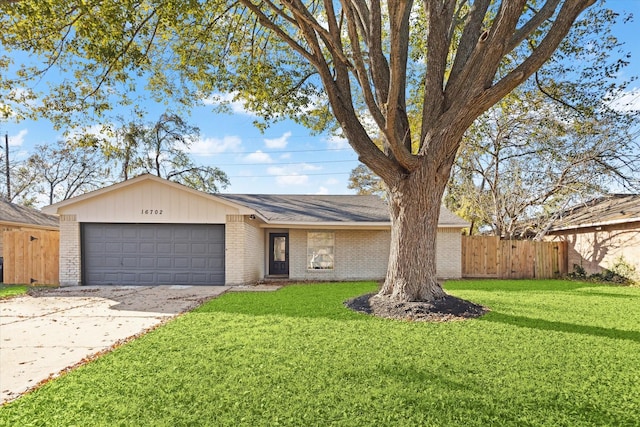 ranch-style home featuring a garage and a front lawn