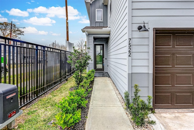 doorway to property with a garage