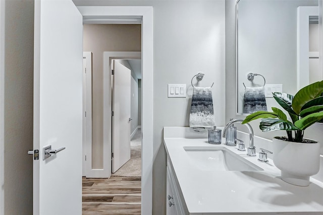 bathroom with hardwood / wood-style floors and vanity