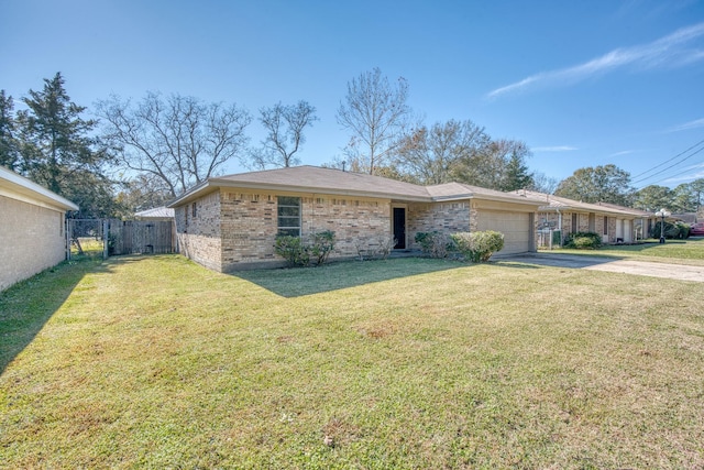 ranch-style house featuring a front lawn and a garage