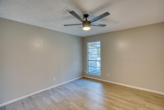 empty room featuring a textured ceiling, ceiling fan, and light hardwood / wood-style flooring