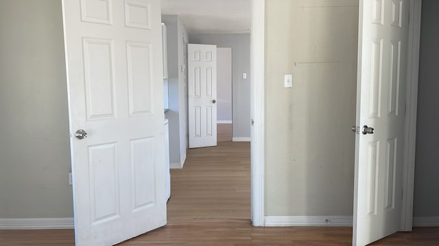 corridor with light hardwood / wood-style flooring