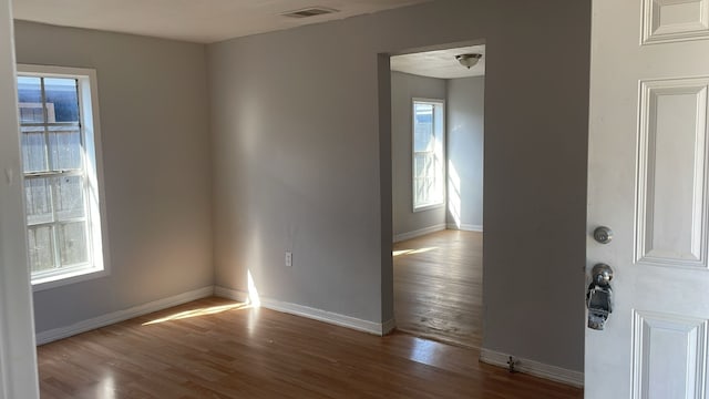 empty room with hardwood / wood-style floors