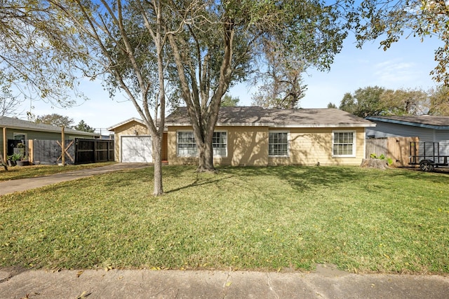 ranch-style home featuring a garage and a front yard