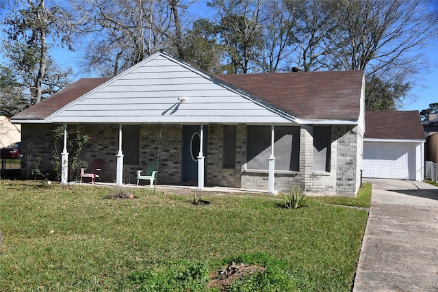 view of front of house featuring a front yard, a porch, and a garage