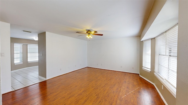 22306 Rustic Bridge Ln, Houston, TX 77339 - spare room featuring ceiling fan, plenty of natural light, and wood finished floors