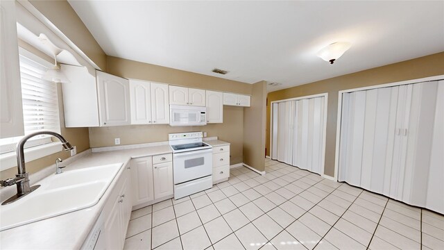 22306 Rustic Bridge Ln, Houston, TX 77339 - kitchen featuring white appliances, a sink, light countertops, white cabinetry, and baseboards