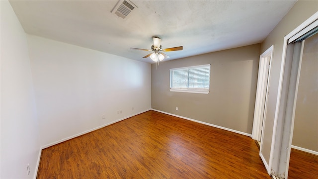 unfurnished bedroom with ceiling fan and hardwood / wood-style floors