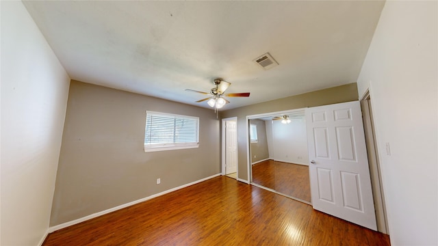 22306 Rustic Bridge Ln, Houston, TX 77339 - unfurnished bedroom with wood finished floors, baseboards, ceiling fan, and a closet