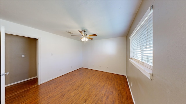 spare room with ceiling fan and hardwood / wood-style flooring