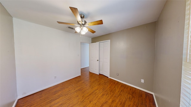 empty room featuring ceiling fan and hardwood / wood-style floors