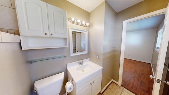 22306 Rustic Bridge Ln, Houston, TX 77339 - half bathroom featuring toilet, vanity, tile patterned flooring, and baseboards