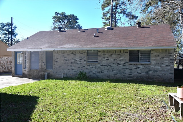 back of house with a lawn