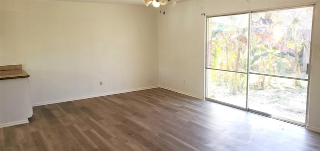 unfurnished room featuring ceiling fan and dark hardwood / wood-style floors