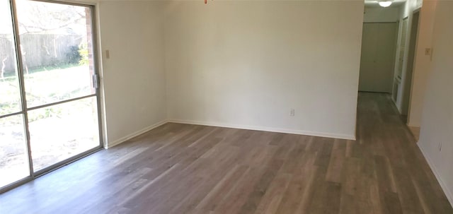 spare room with dark hardwood / wood-style flooring