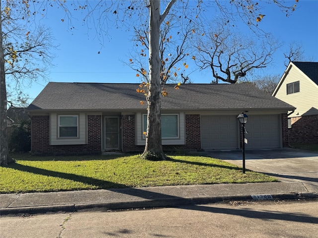 ranch-style house featuring a front yard and a garage