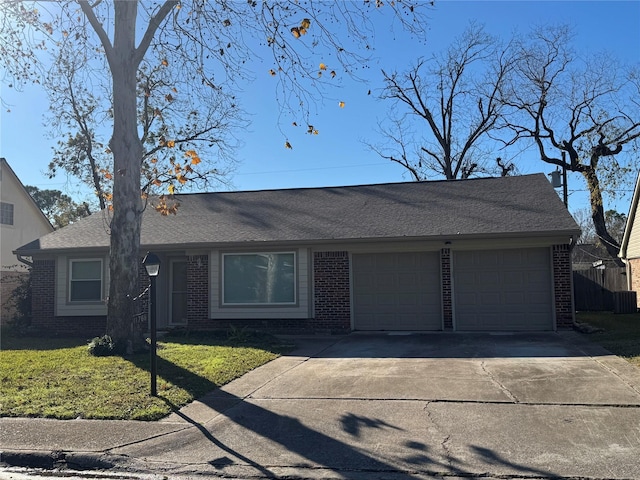 ranch-style home with a garage and a front yard