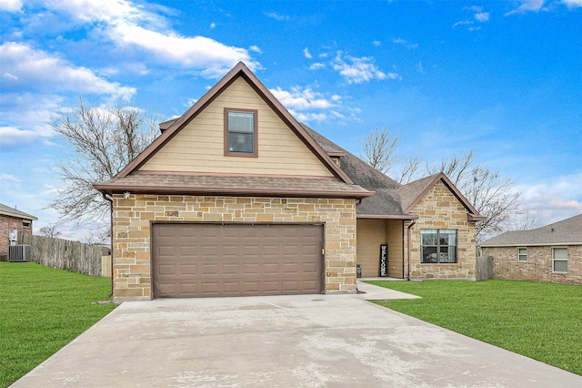 view of front of home with a garage, cooling unit, and a front lawn