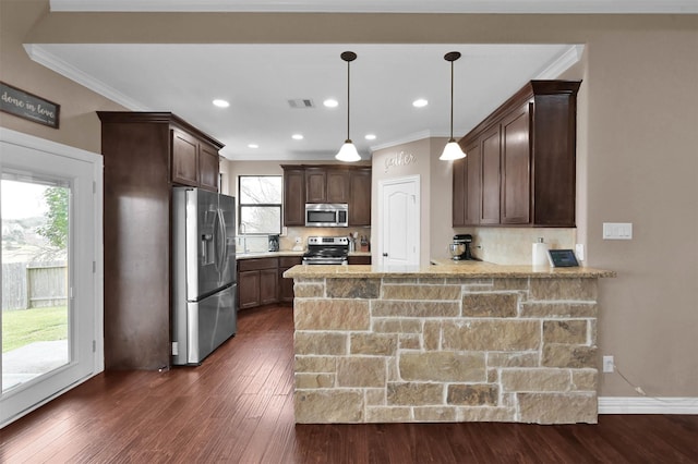 kitchen with kitchen peninsula, decorative backsplash, stainless steel appliances, and pendant lighting