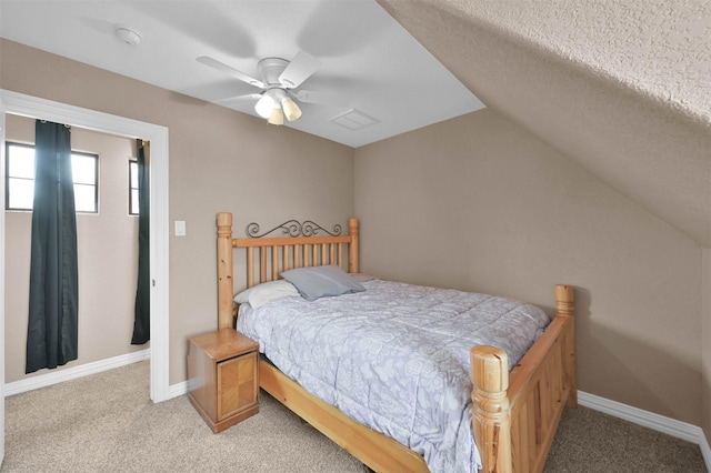 carpeted bedroom with vaulted ceiling and ceiling fan