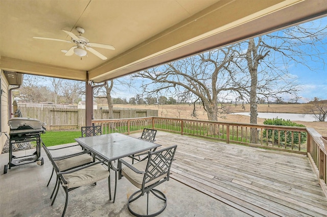 exterior space featuring grilling area, ceiling fan, and a deck with water view