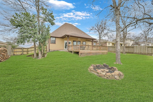 view of yard featuring a wooden deck and an outdoor fire pit