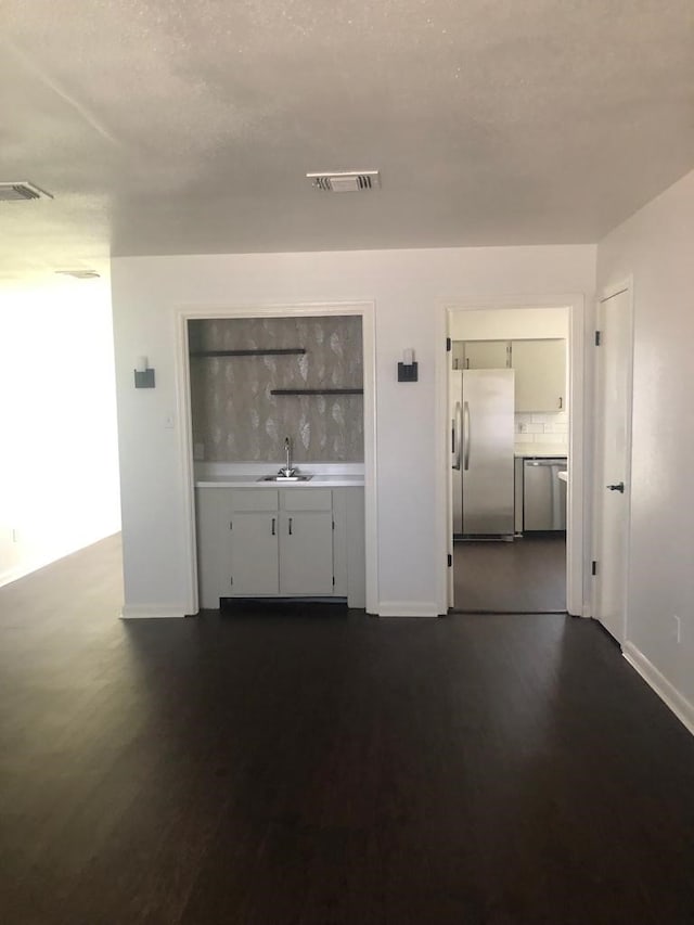 interior space featuring dark hardwood / wood-style flooring and sink