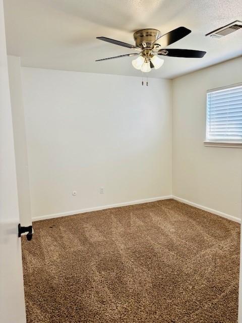 carpeted empty room featuring ceiling fan