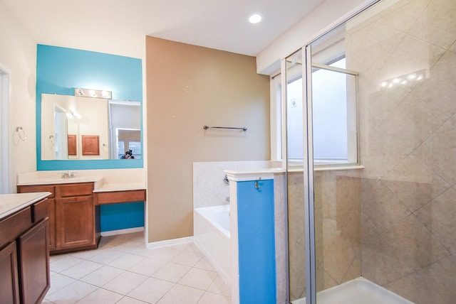 bathroom featuring tile patterned flooring, vanity, and shower with separate bathtub