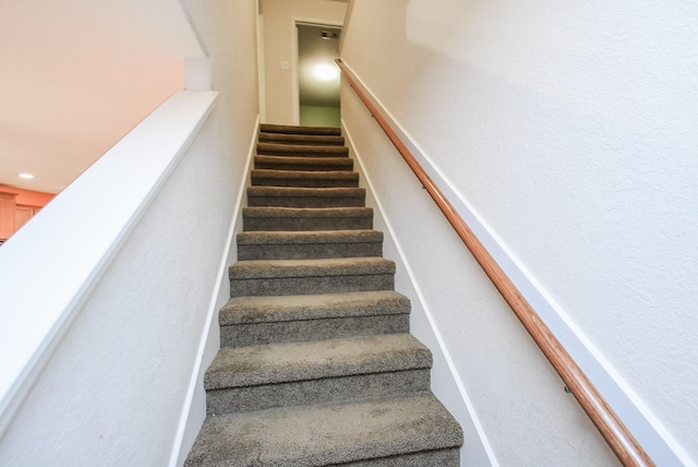 stairway featuring recessed lighting