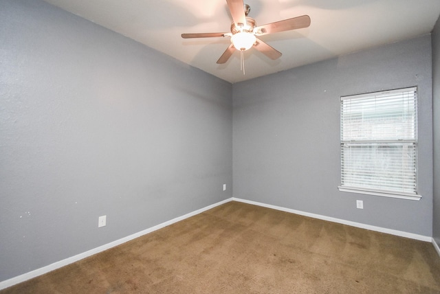 unfurnished room featuring ceiling fan and carpet flooring