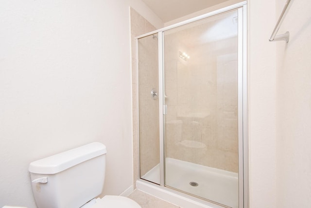 bathroom featuring a shower stall and toilet