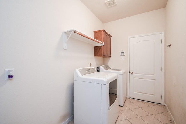 laundry room featuring light tile patterned floors, visible vents, baseboards, cabinet space, and independent washer and dryer