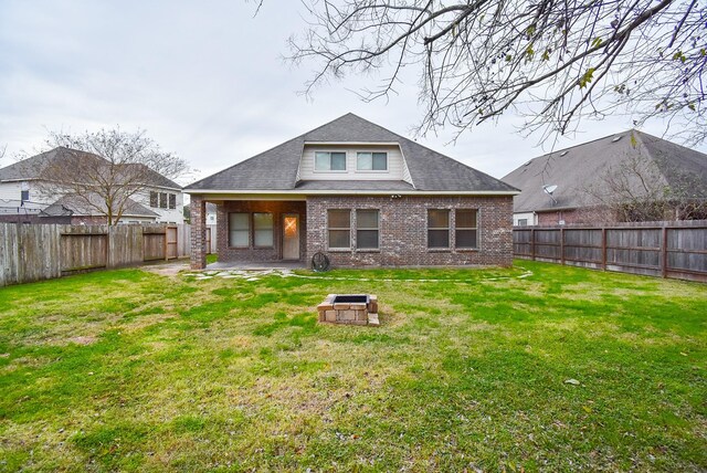 rear view of property featuring a patio area and a lawn